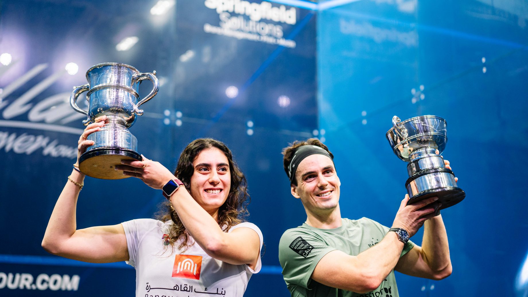 Nour El Sherbini & Paul Coll lifting the trophies