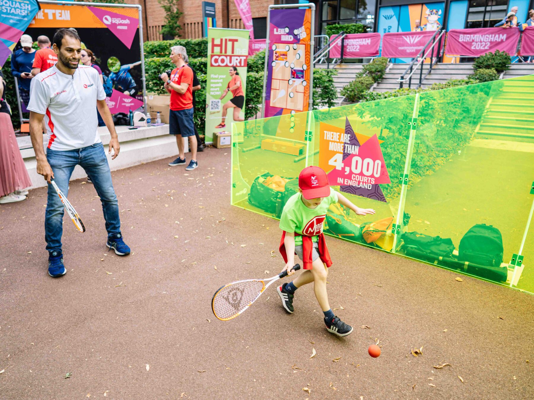 Mohamed ElShorbagy (left) has a hit with a child on a mini court in Birmingham.