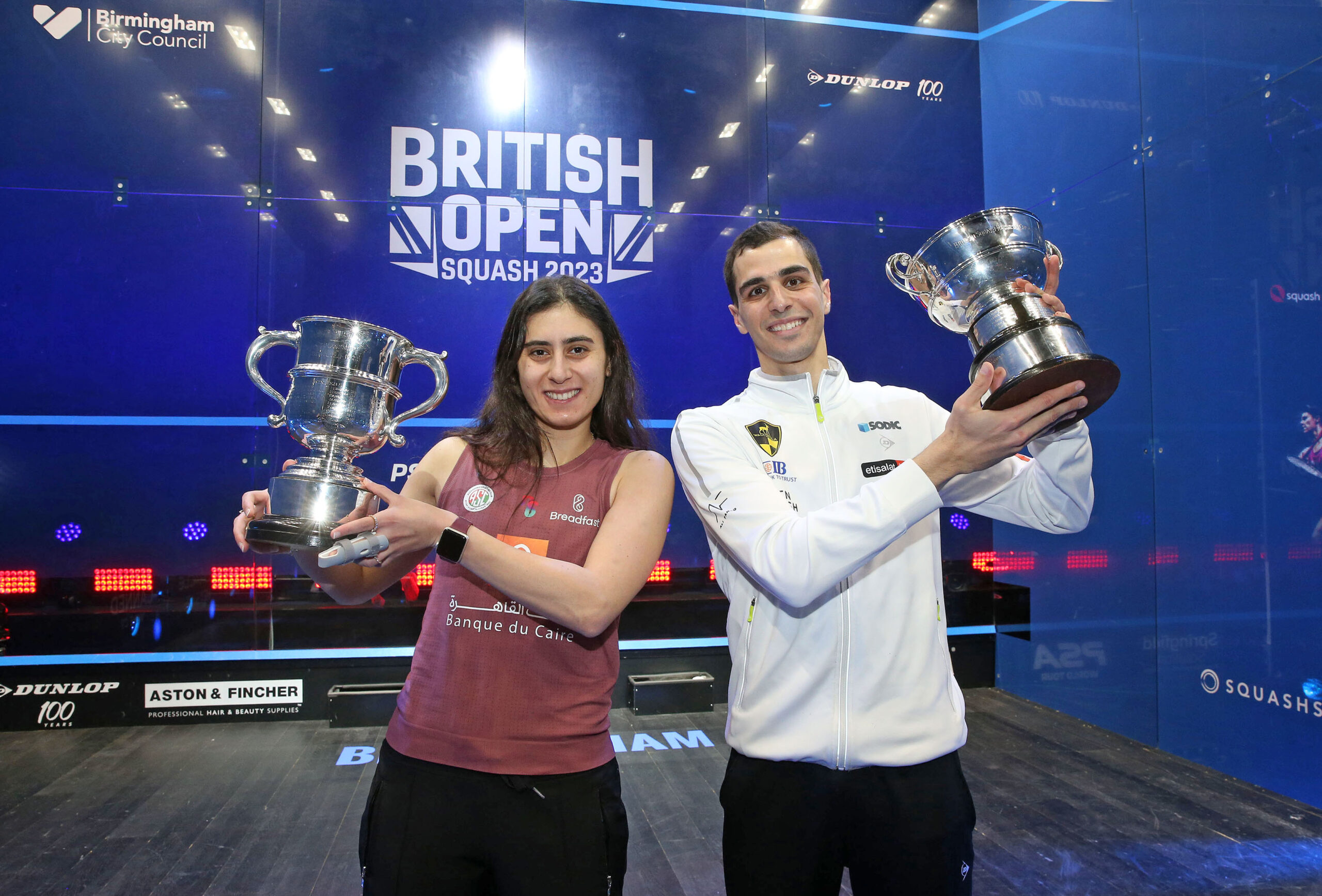 Nour El Sherbini and Ali Farag with the 2023 British Open trophies.