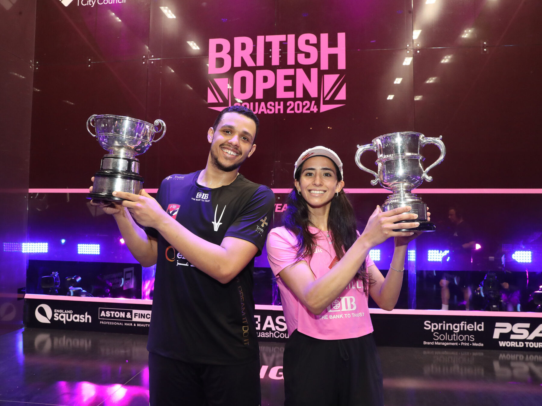 Mostafa Asal (left) and Nouran Gohar (right) with the 2024 British Open trophies.